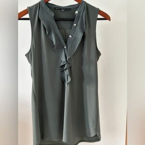 Green sleeveless blouse from White House black market. Ruffled front.